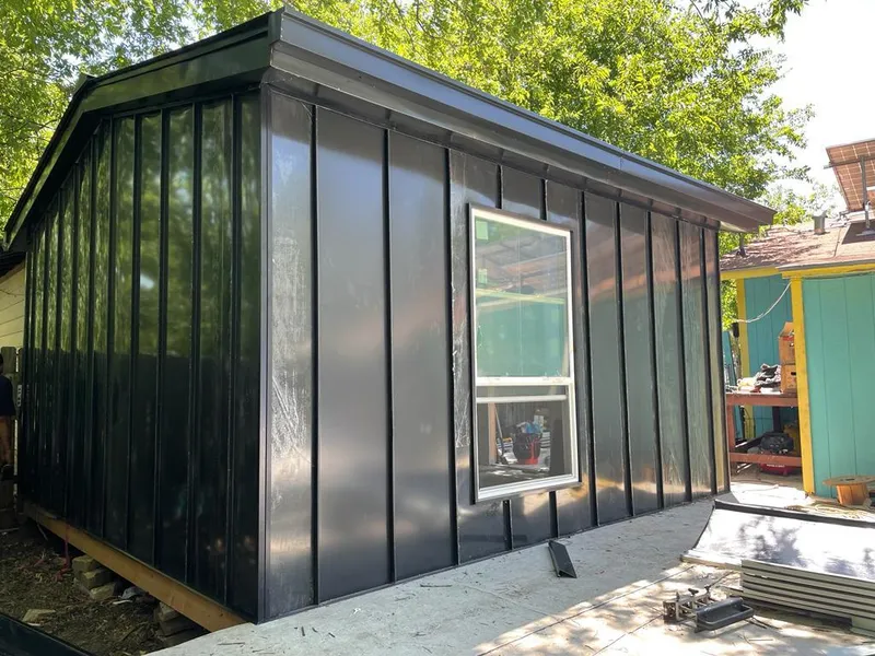 Black standing seam metal wall panels for Roof Inspection in Raymore