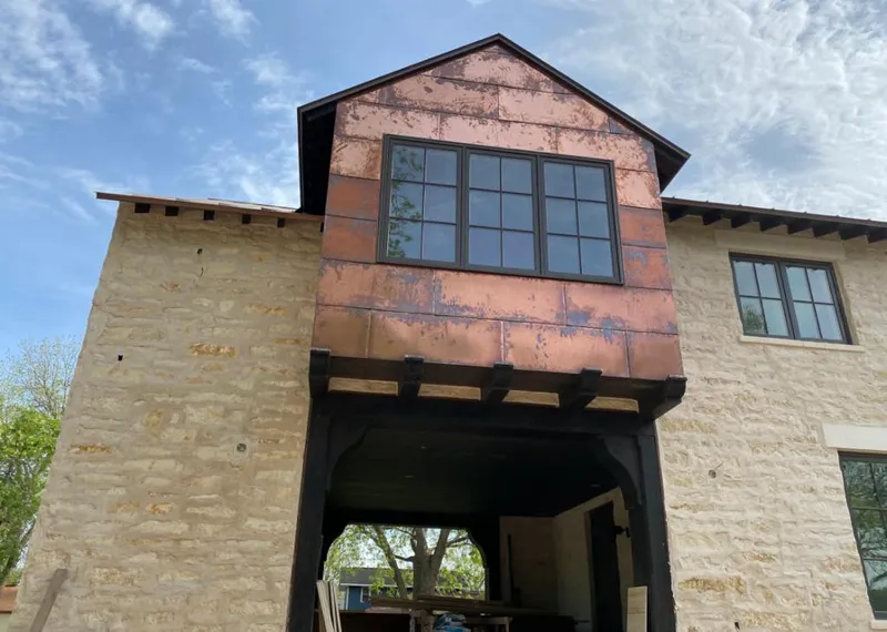 Copper metal panel facade on a stone building for Metal Roof Coating in Raymore