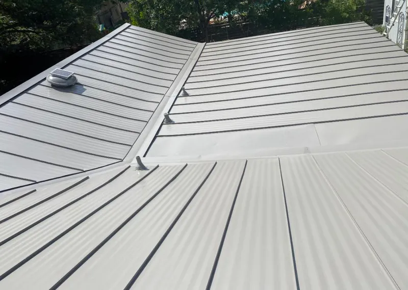 Solar attic fan installed on a metal roof for Roof Ventilation in Raymore